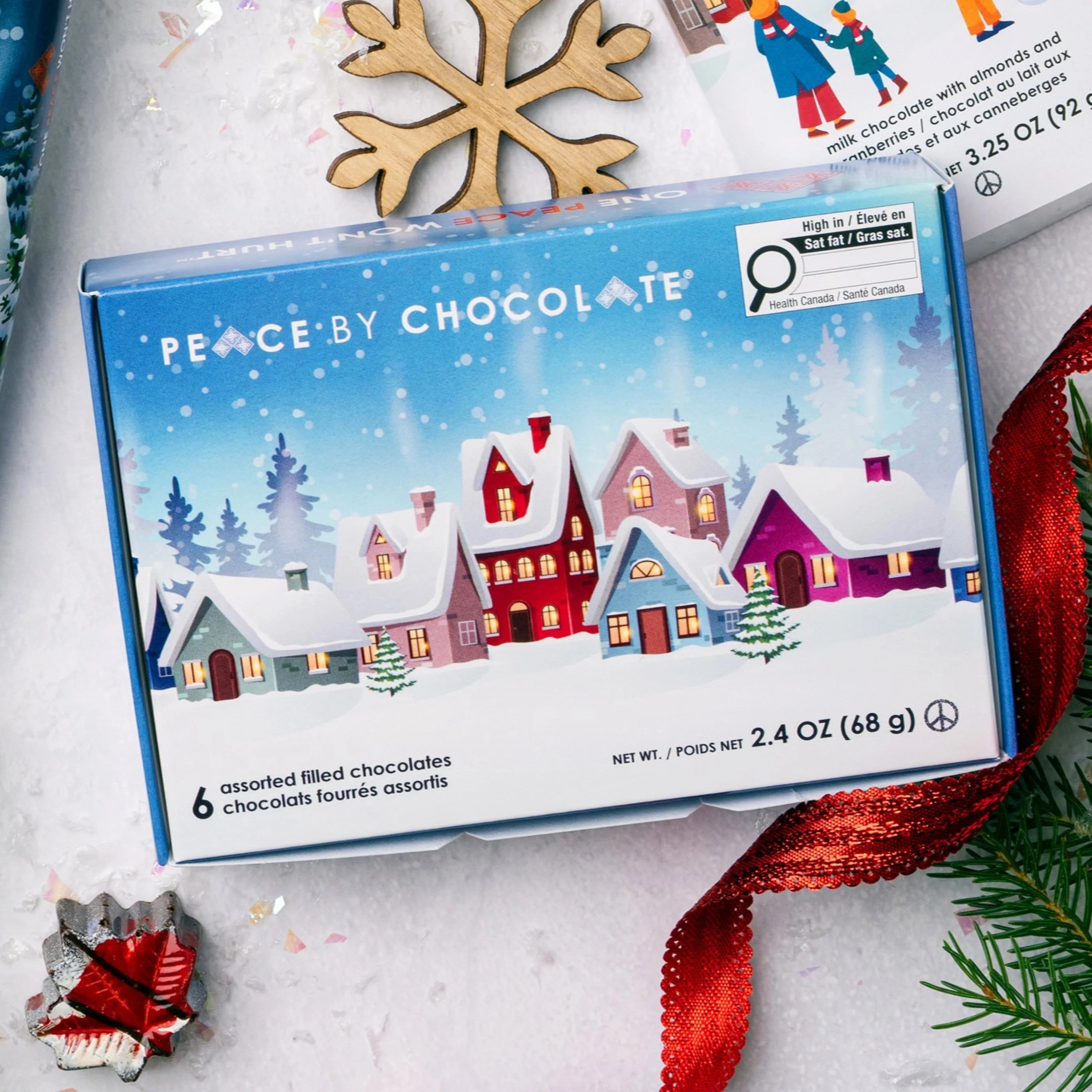 Box of Peace by Chocolate assorted filled chocolates with a winter village design on the packaging.