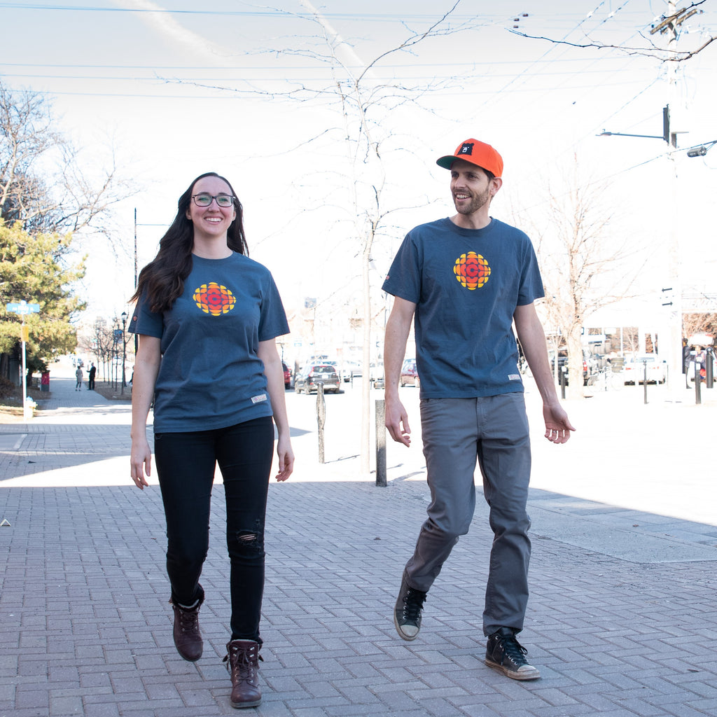 Gareth and Kass walk along a street, both wearing a CBC Gem shirt.