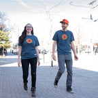 Gareth and Kass walk along a street, both wearing a CBC Gem shirt.