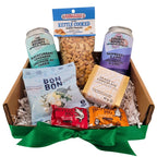 Gift basket with snacks and drinks including Bounty soda, kettle cooked peanuts, and chocolate bars.
