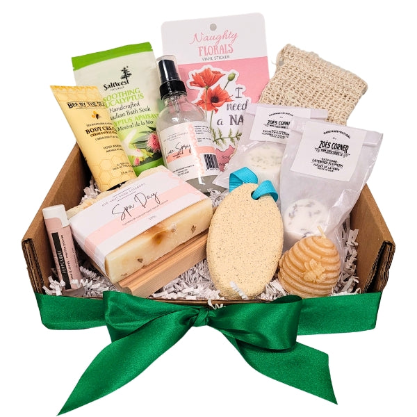 Gift basket with various items including soap, scrub, and bath products on a white background