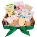 Gift basket with various items including soap, scrub, and bath products on a white background