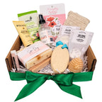 Gift basket with various items including soap, scrub, and bath products on a white background