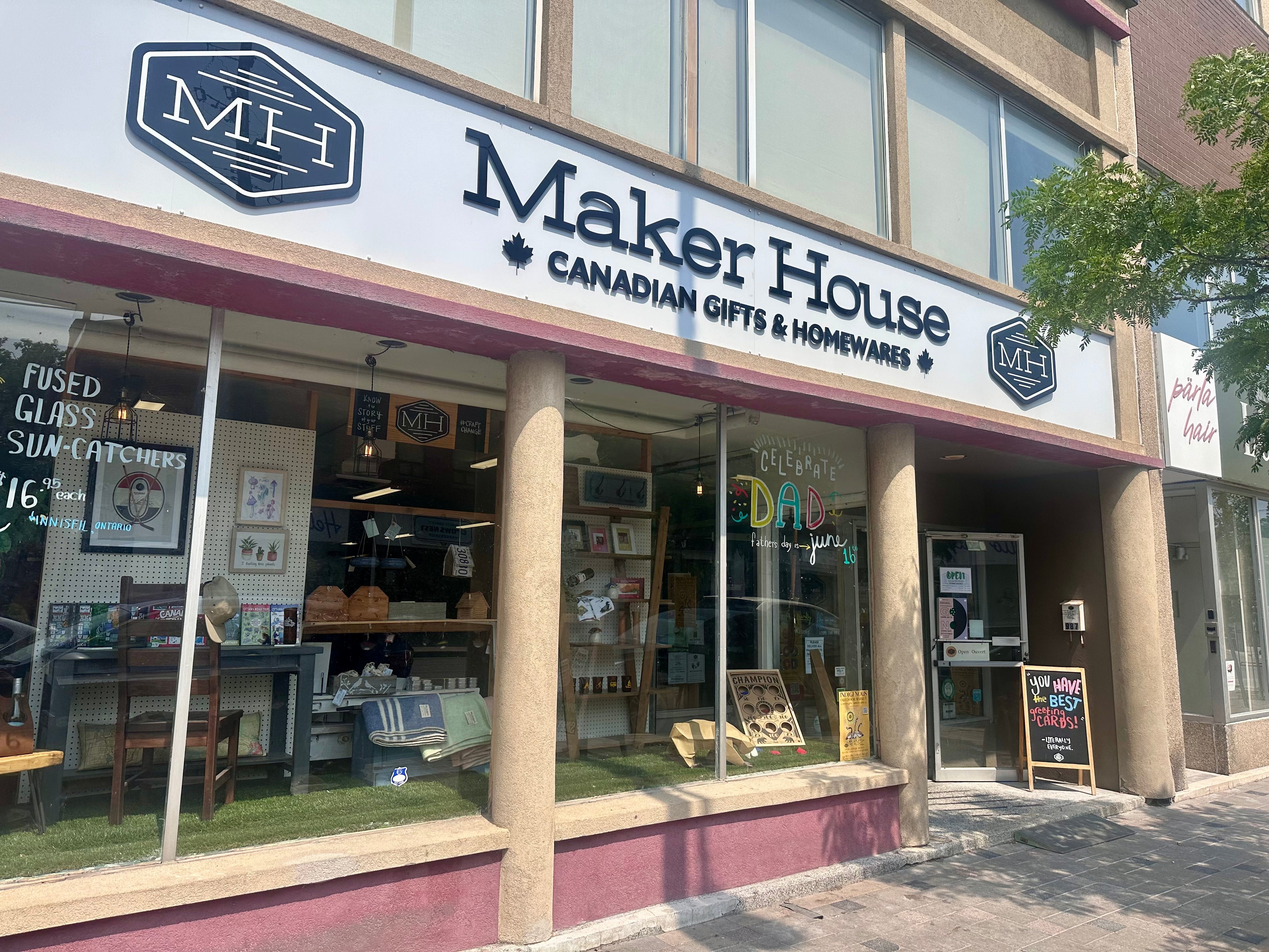Maker House store front with 'MH' logo on a clear day