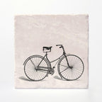 A coaster with a vintage bike printed on it.