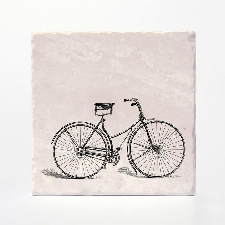 A coaster with a vintage bike printed on it.