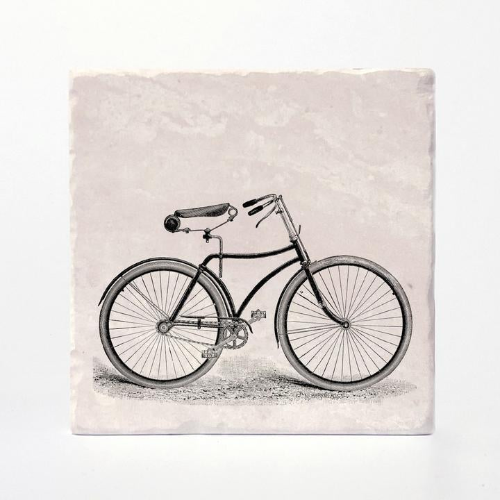 A coaster with a vintage bike printed on it.