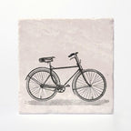 A coaster with a vintage bike printed on it. 