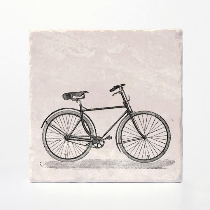 A coaster with a vintage bike printed on it. 