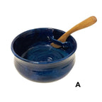 Blue ceramic bowl with slot on side to hold wooden knife.