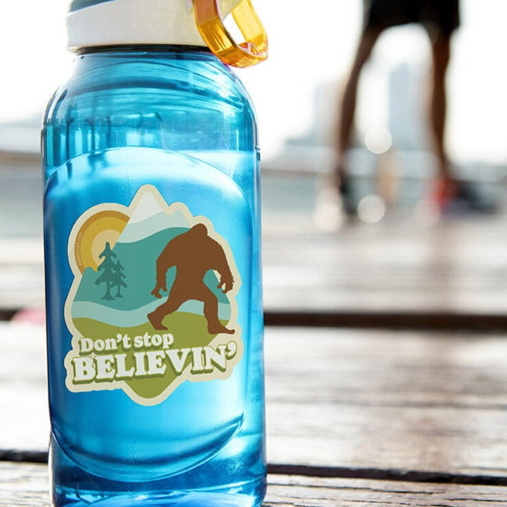 Don't stop believin' big foot sticker on a blue water bottle.