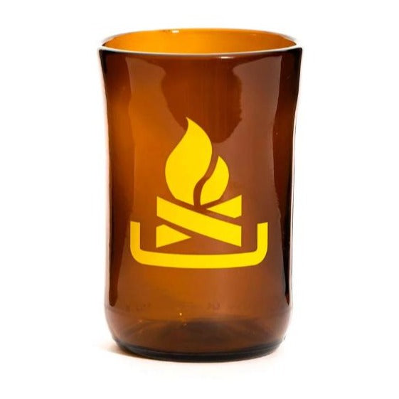 Image is of a transparent brown glass tumbler with a simple yellow fire pit outline decal.