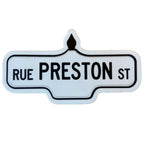 Sticker of a white street sign with black text that reads 'Rue Preston St.'