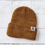Plain mustard-colored marl toque with tiny white label with bear logo on it.